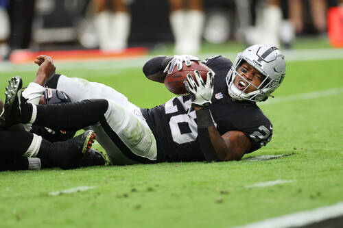 Raiders running back Josh Jacobs (28) is tackled short of the end zone during the first half of ...