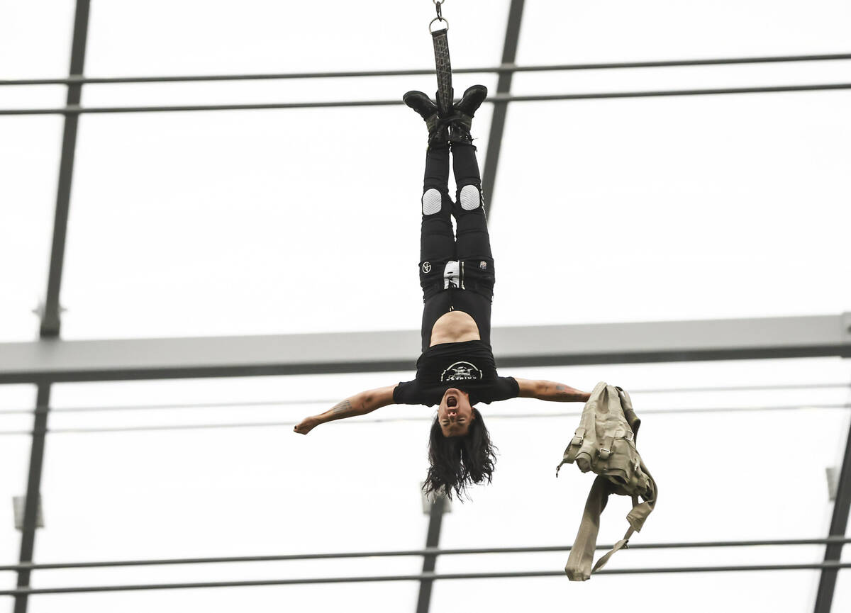 Magician and "Mindfreak" star Criss Angel, dangling over 100 feet in the air in Alleg ...