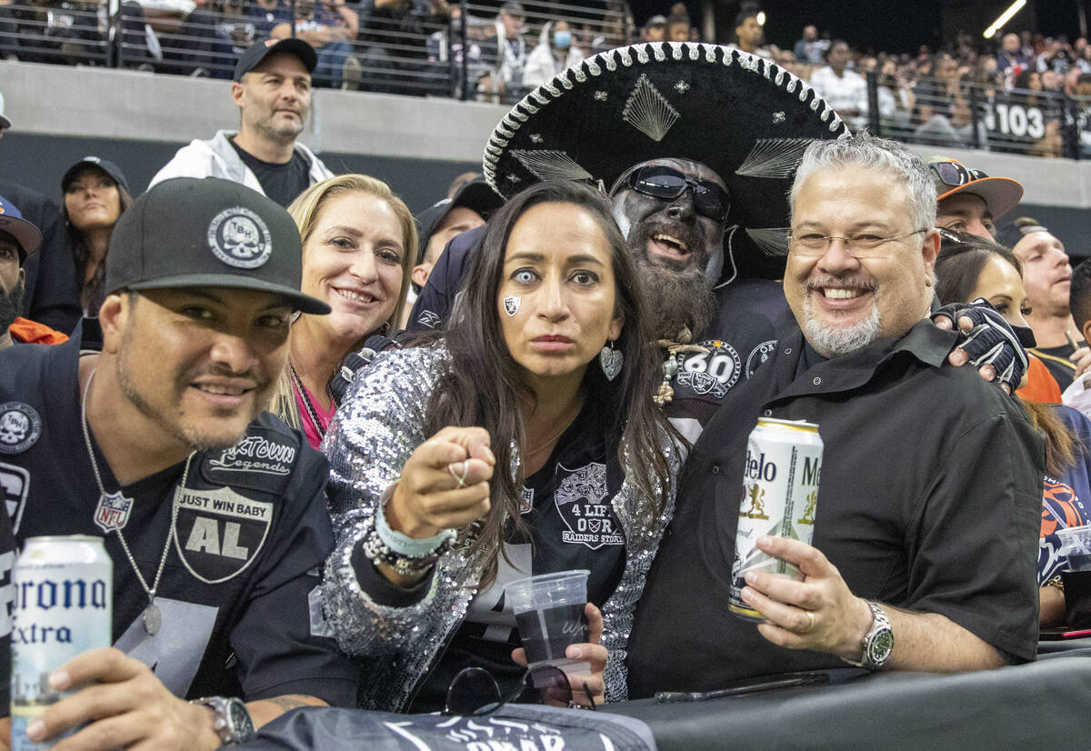Raiders fans pose during the fourth quarter of an NFL football game against the Chicago Bears o ...