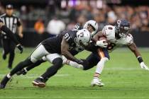 Chicago Bears running back Damien Williams (8) is tackled by Raiders defensive end Yannick Ngak ...
