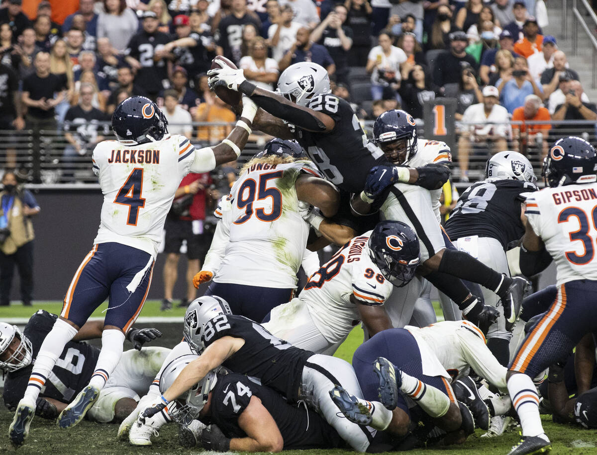 Raiders running back Josh Jacobs (28) scores a touche down against Chicago Bears during the sec ...