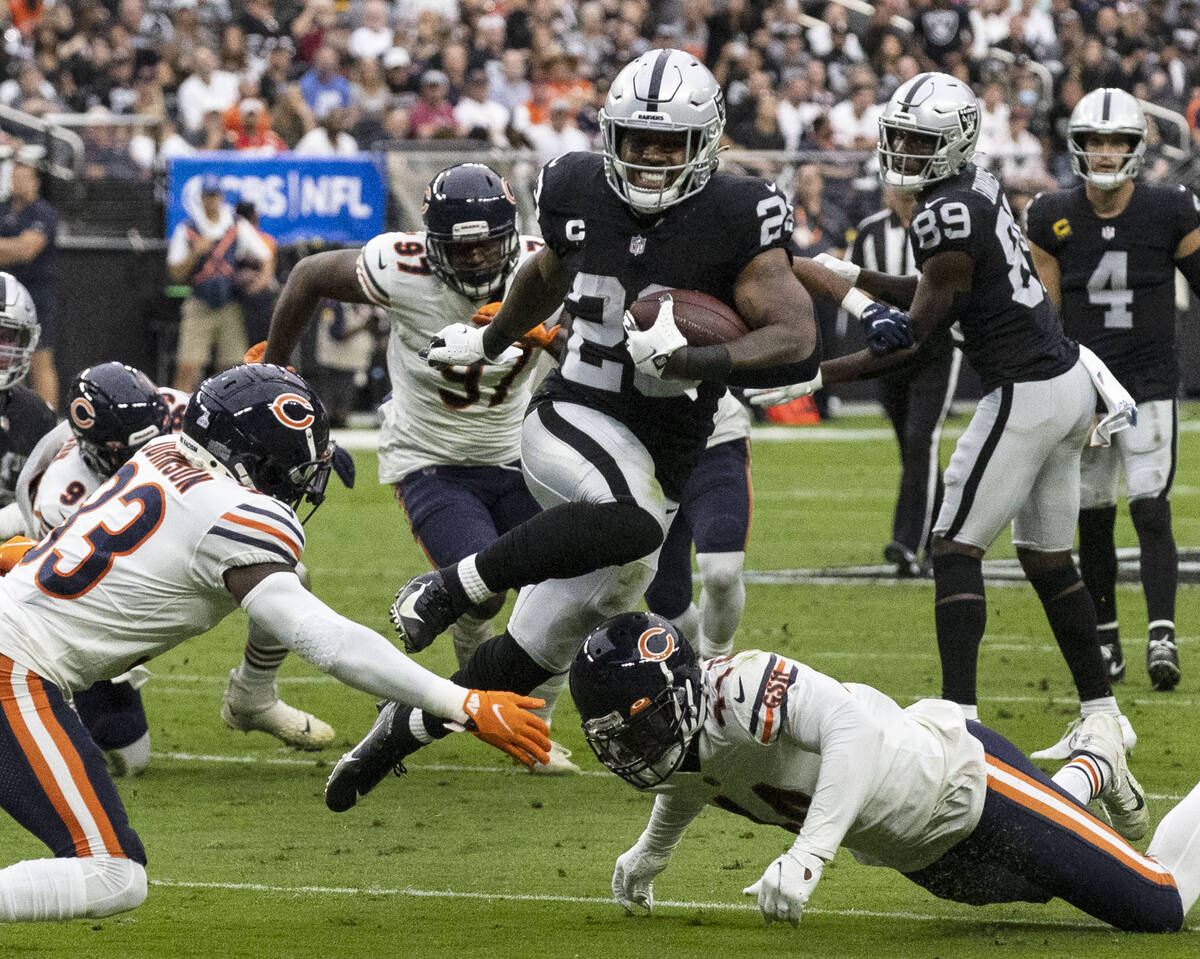 Raiders running back Josh Jacobs (28) eludes Chicago Bears defenders during the second half of ...