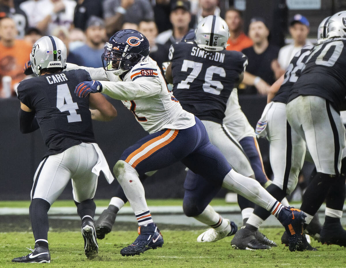 Chicago Bears outside linebacker Khalil Mack (52) sacks Raiders quarterback Derek Carr (4) in t ...