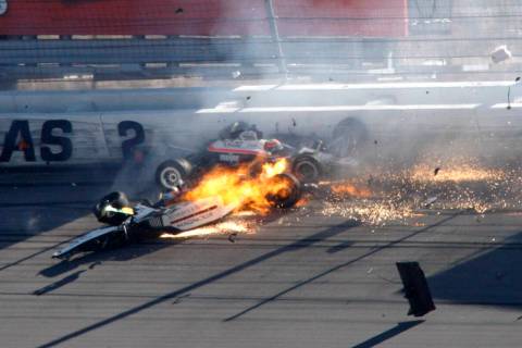 Dan Wheldon, front left, and another driver crash during a wreck that involved 15 cars during t ...