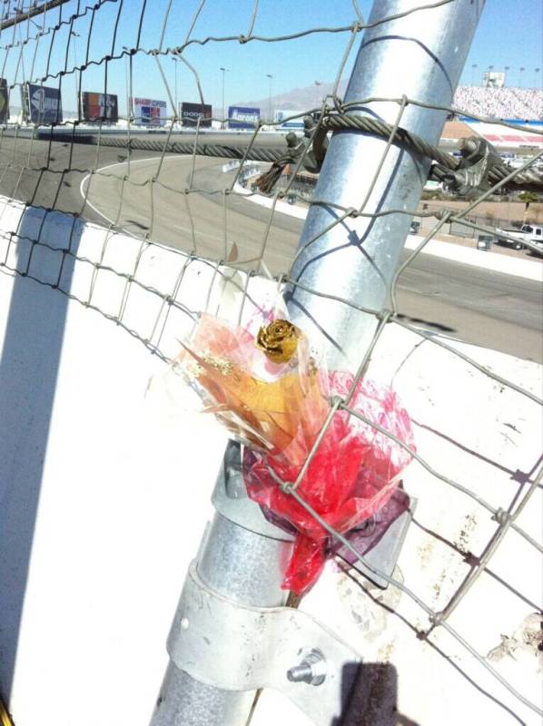 Flowers are attached to a pole in the Turn 2 catchfence at Las Vegas Motor Speedway where two-t ...