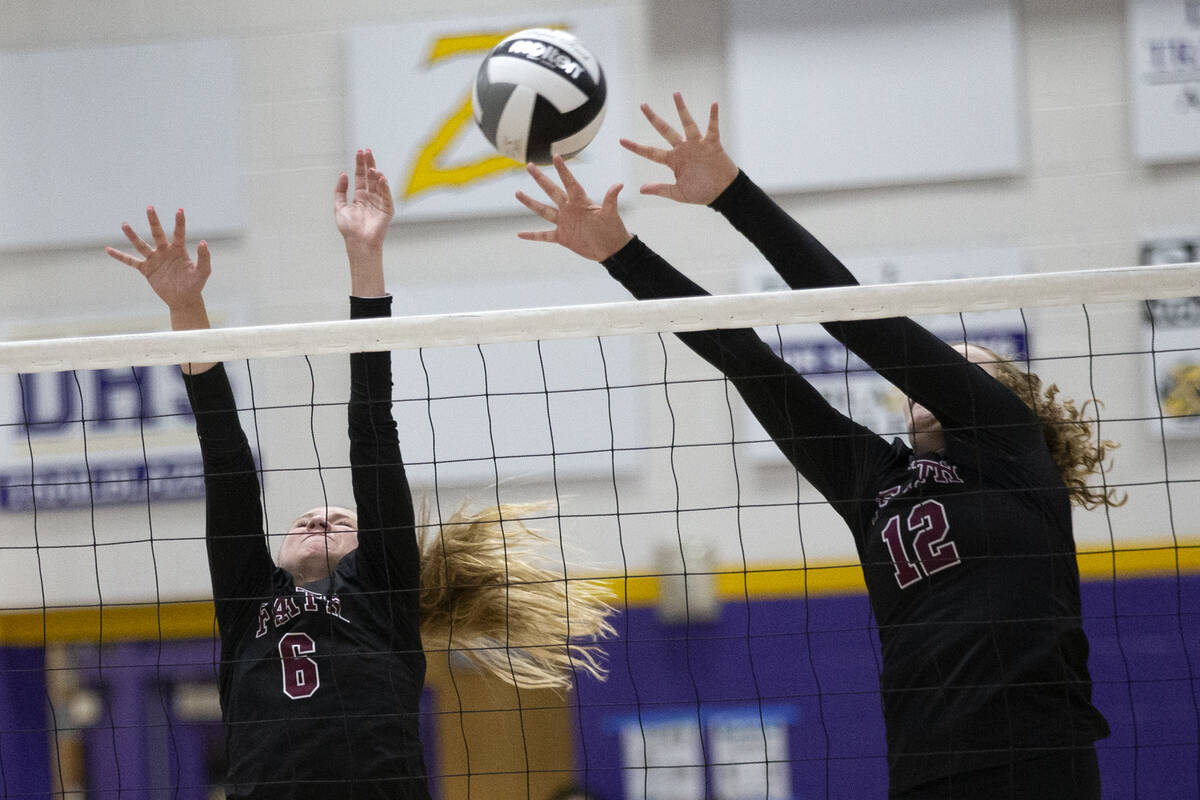 Faith Lutheran's Bianca Richardson (6) and Delaney Wilson (12) attempt to kill a Durango spike ...