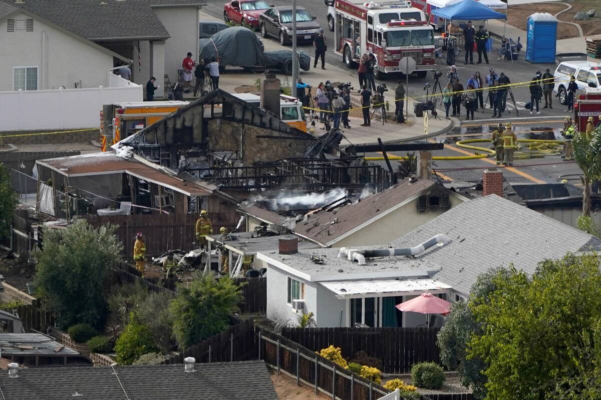 Emergency crews work a the scene of a small plane crash, Monday, Oct. 11, 2021, in Santee, Cali ...