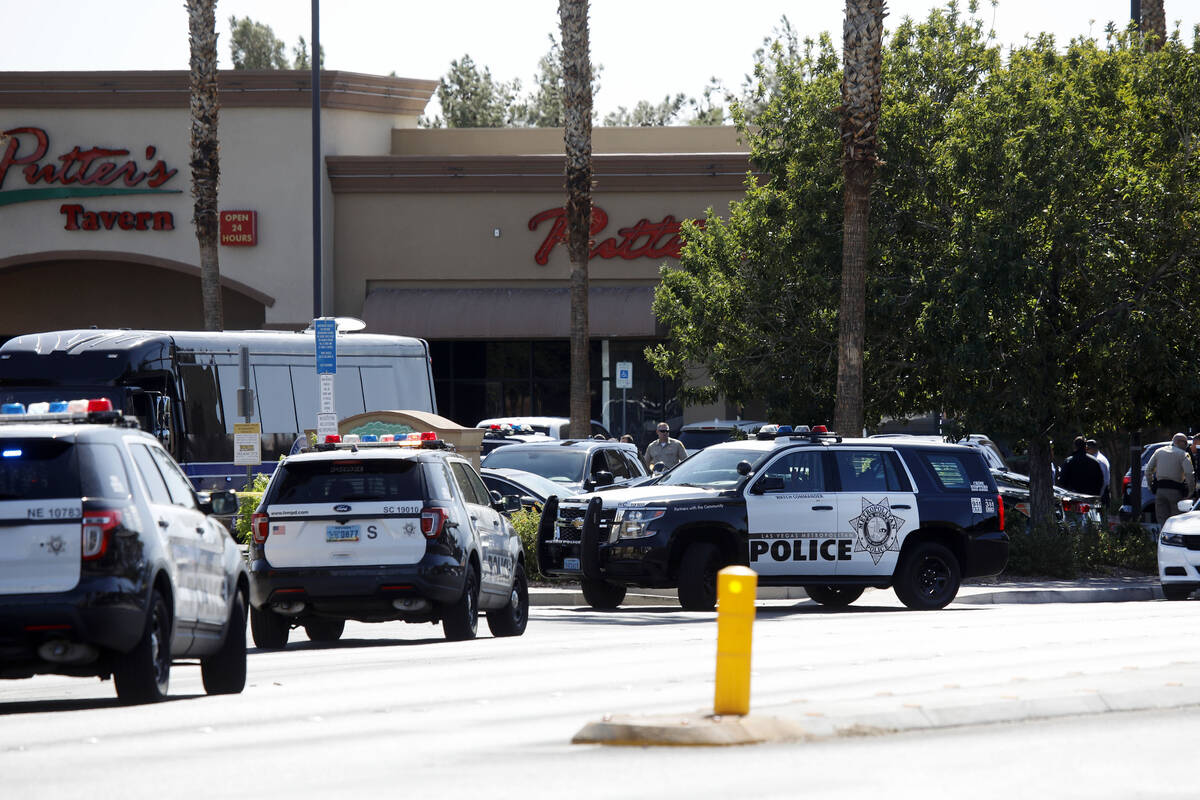 Las Vegas police investigate a police shooting at Charleston Boulevard and Sloan Lane on Tuesda ...