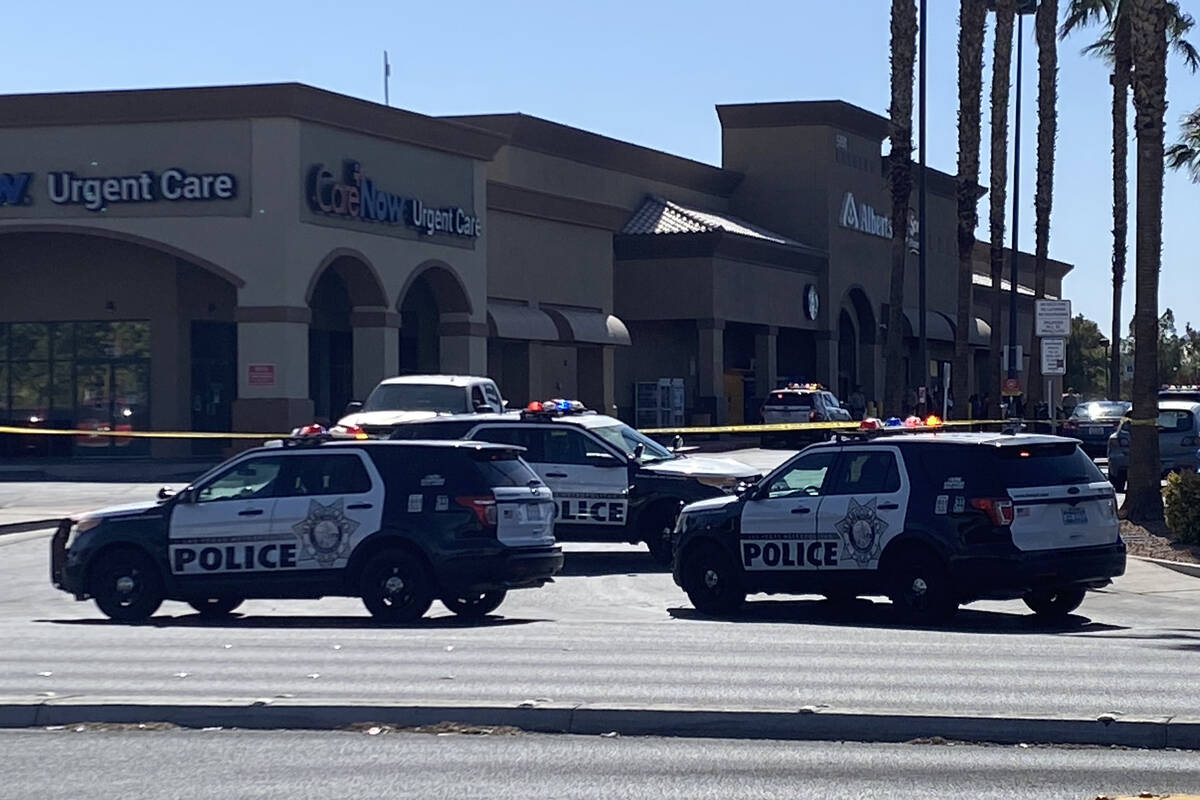 Las Vegas police investigate a police shooting at Charleston Boulevard and Sloan Lane in Las Ve ...