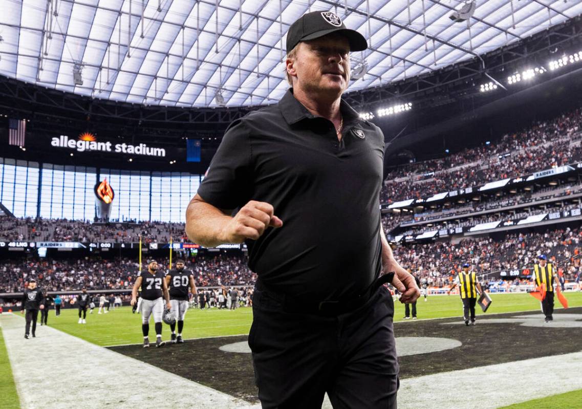 Raiders head coach Jon Gruden jogs off the field after an NFL football game against the Chicago ...