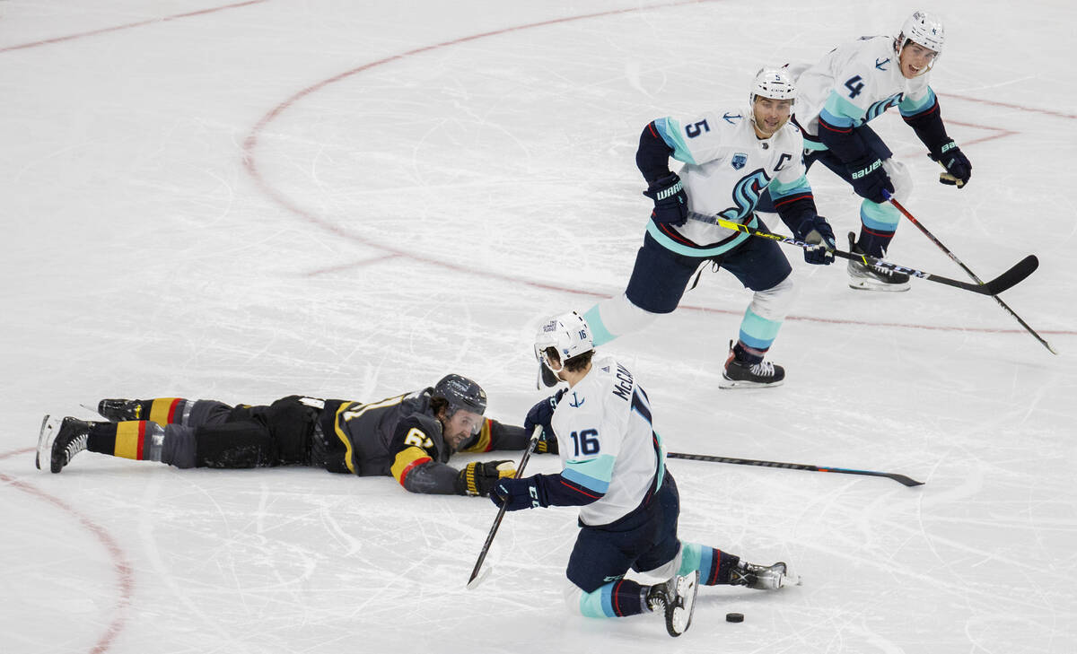 Vegas Golden Knights right wing Mark Stone (61) is knocked to the ice by Seattle Kraken center ...