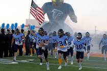 Foothill High School's players run out to the field before a football game against Legacy High ...