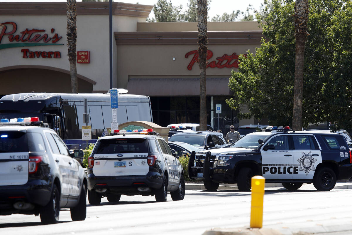 Las Vegas police investigate a police shooting at Charleston Boulevard and Sloan Lane on Tuesda ...