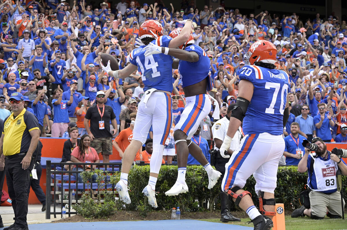Florida wide receiver Trent Whittemore (14) and wide receiver Justin Shorter (4) celebrate afte ...