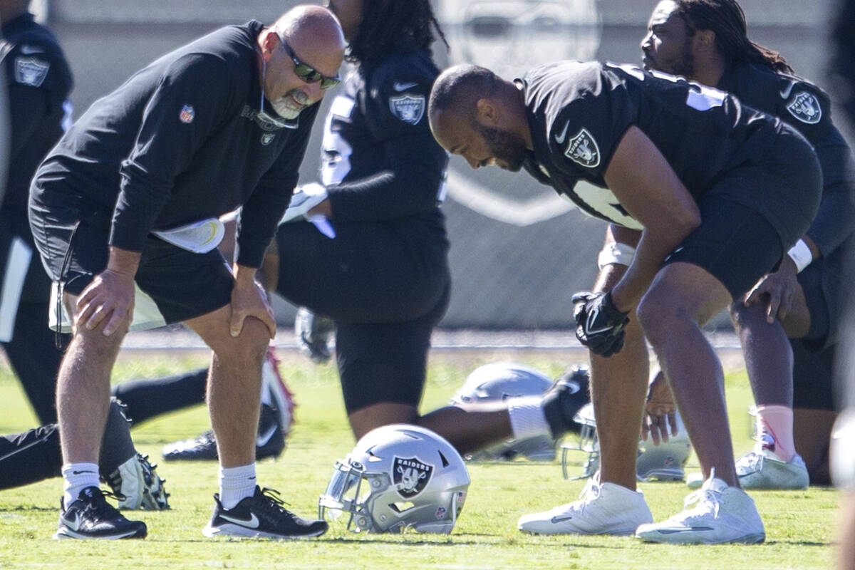 Raiders interim head coach Rich Bisaccia, left, shares a laugh with Raiders outside linebacker ...