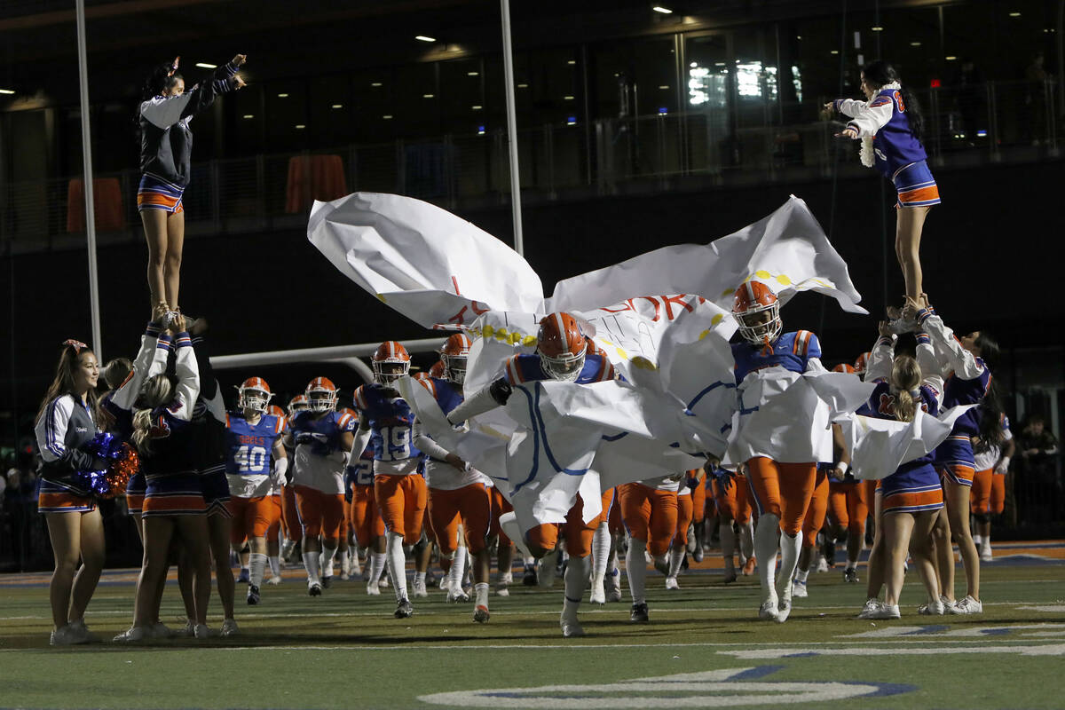 Bishop Gorman High School's players run out to the field before the second half of a football g ...