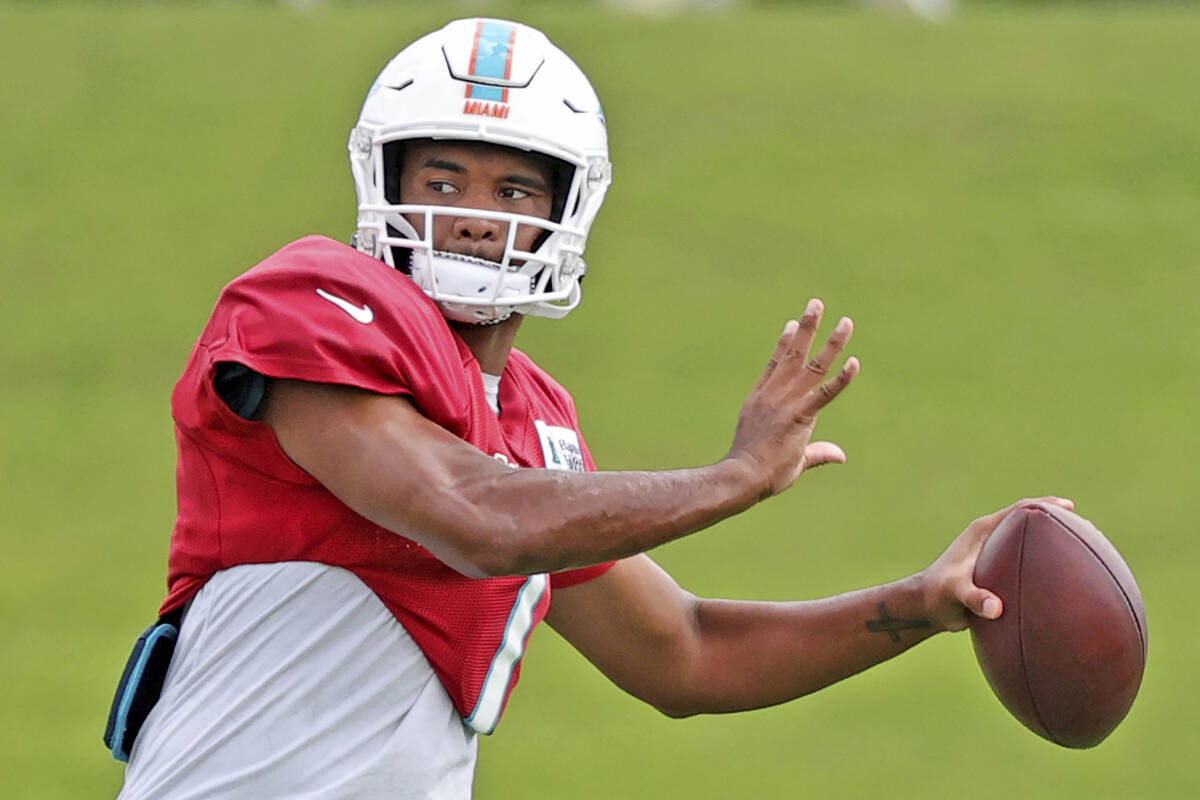 Miami Dolphins quarterback Tua Tagovailoa (1) sets up to pass during NFL football practice in M ...