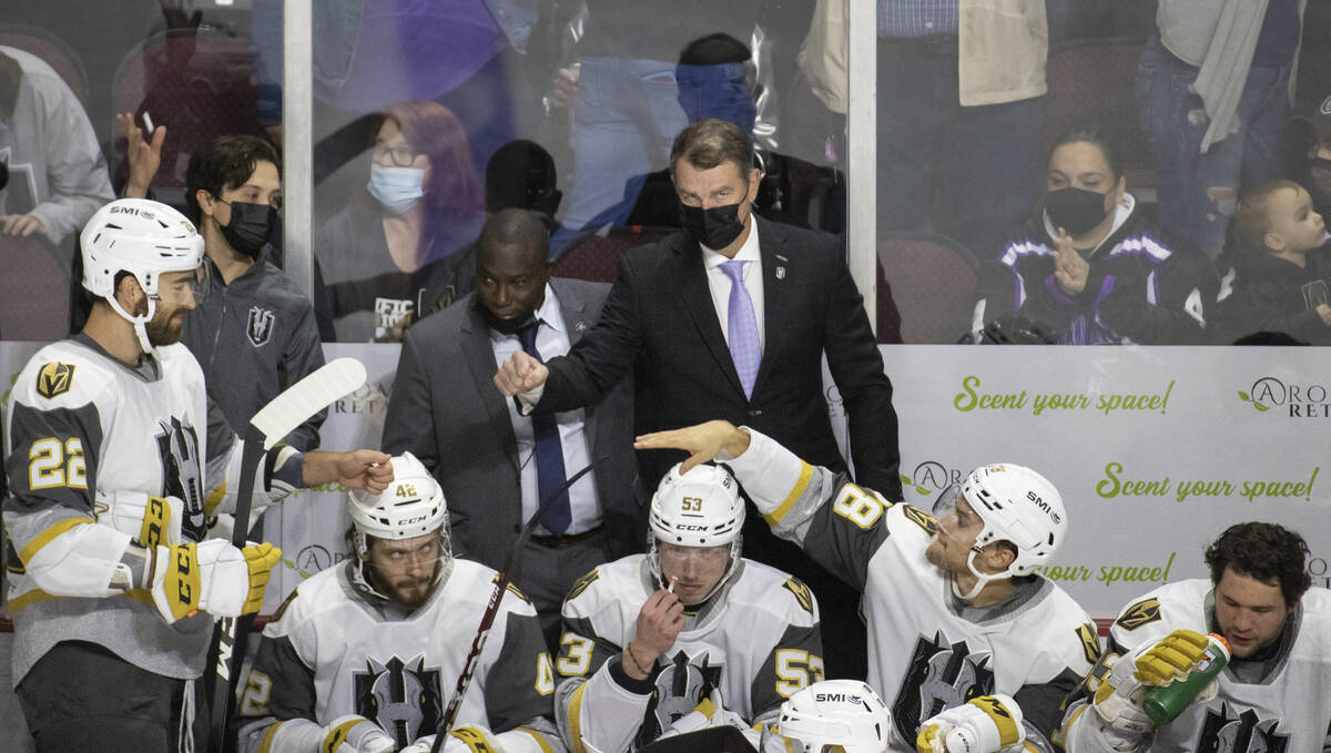 The Silver Knights coaching staff interacts with players during an AHL hockey game against the ...