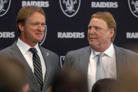 Jon Gruden, left, after being announced as the head coach of the Raiders with owner Mark Davis ...