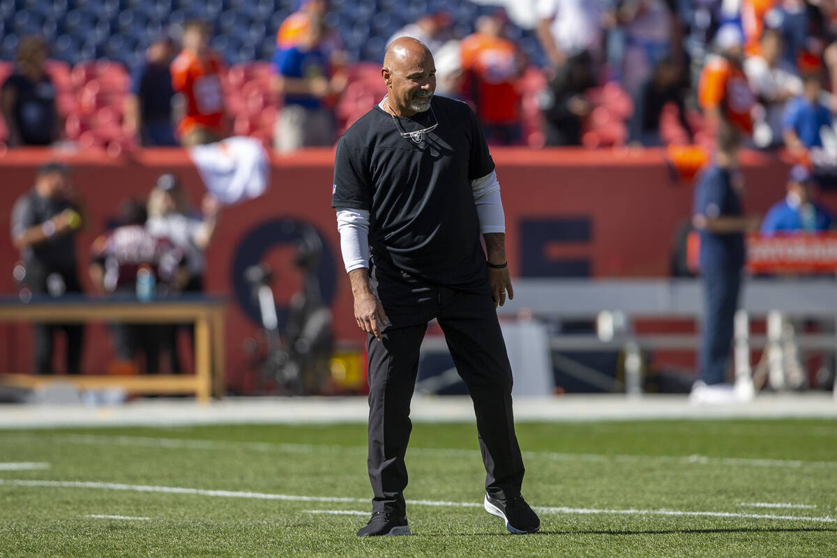 Raiders interim head coach Rich Bisaccia takes the field for warm ups before an NFL football ga ...