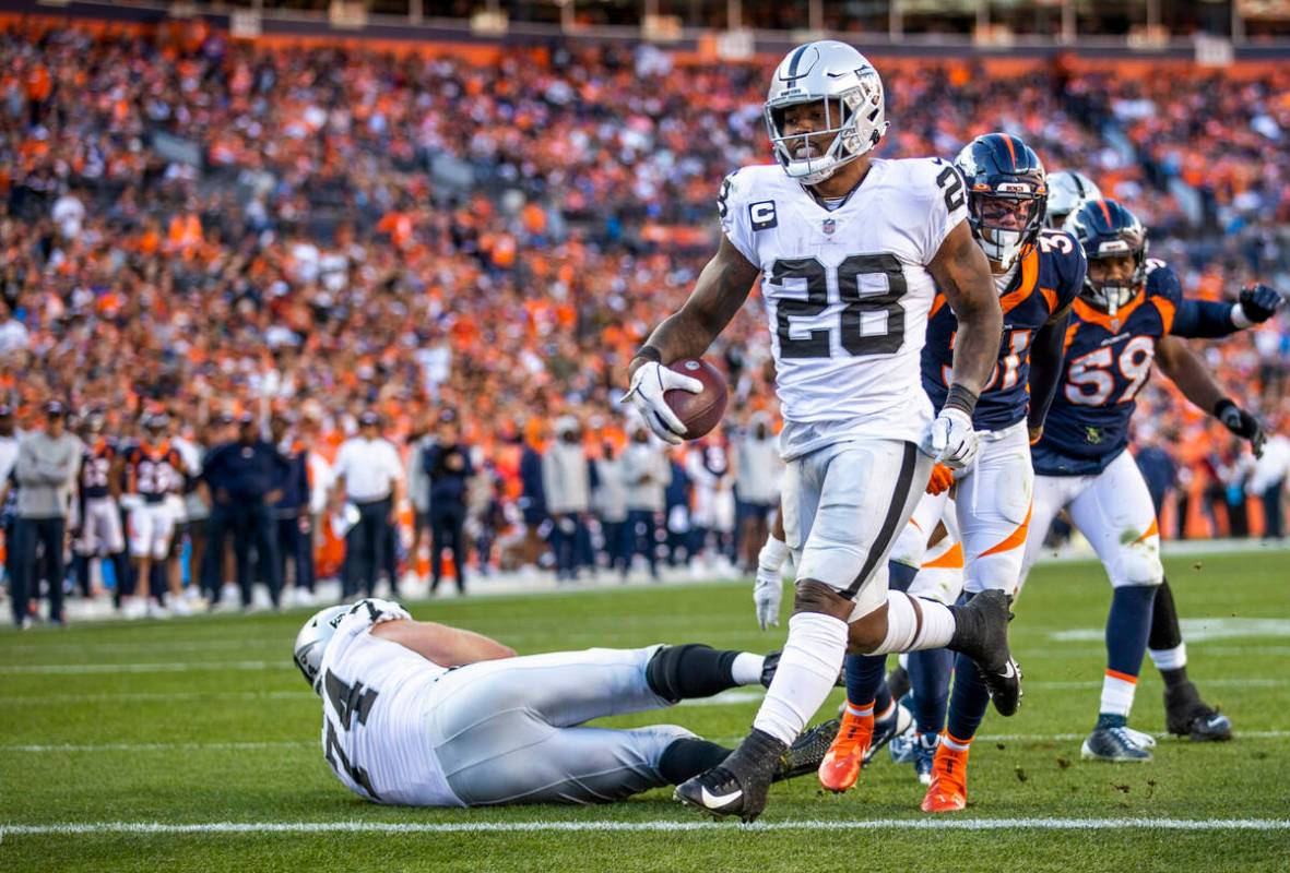 Raiders' running back Josh Jacobs (28) eases into the end zone over the Denver Broncos during t ...
