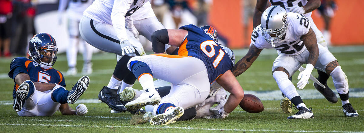 Raiders' defensive back Keisean Nixon (22, right) eyes a fumble by Denver Broncos quarterback T ...