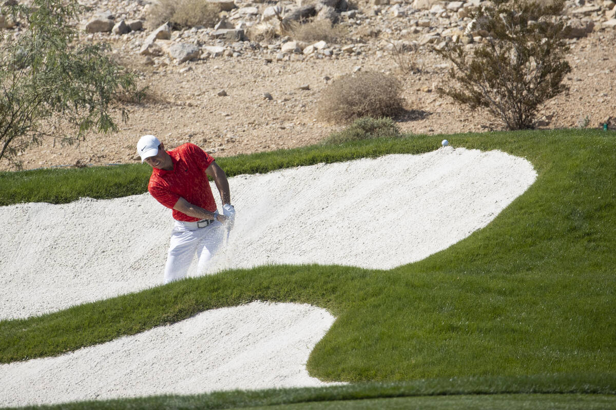 Rory McIlroy hits the ball from a bunker on to the fifth green during the final round of the CJ ...