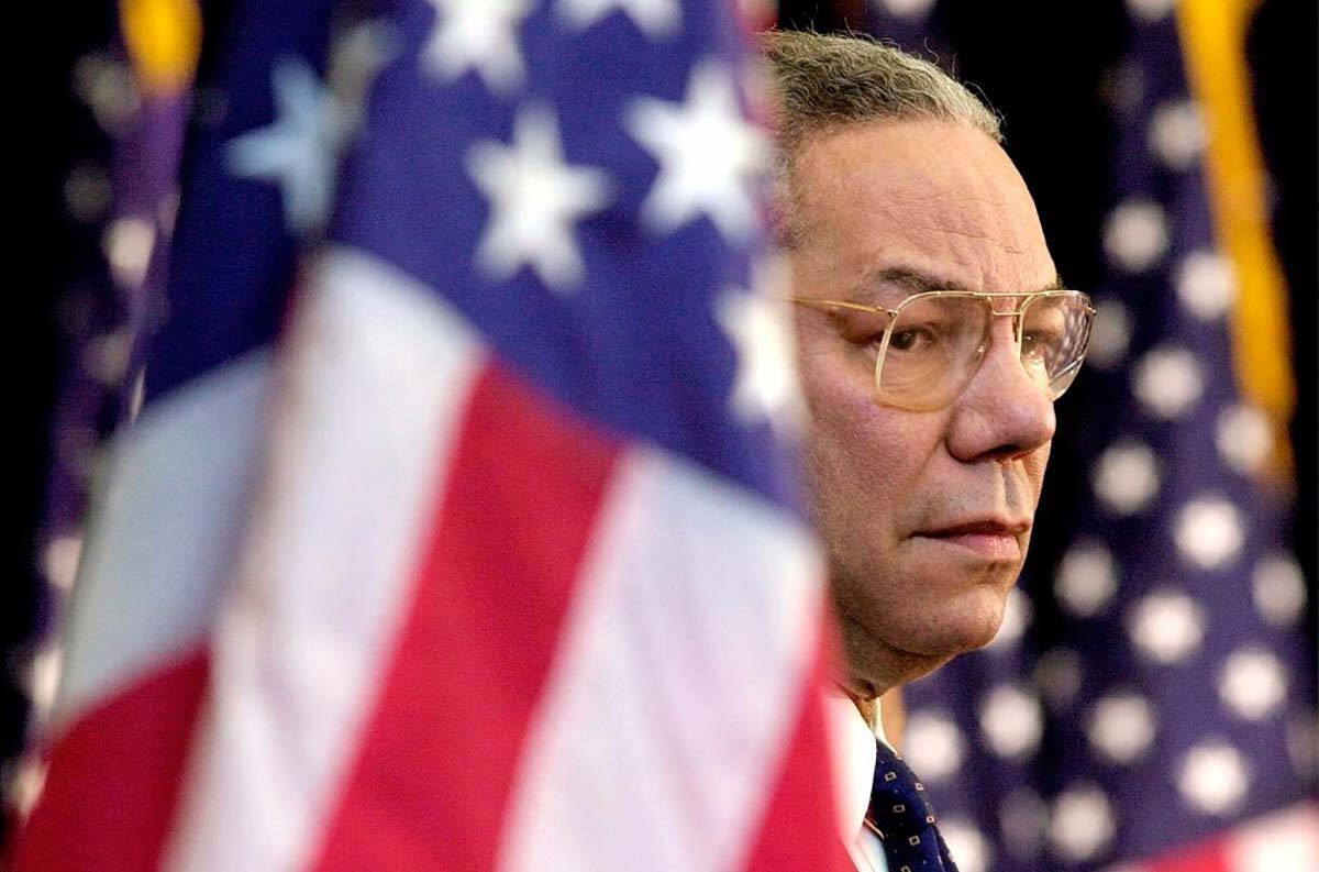 FILE - In this Feb. 15, 2001 file photo, Secretary of State Colin Powell looks on as President ...