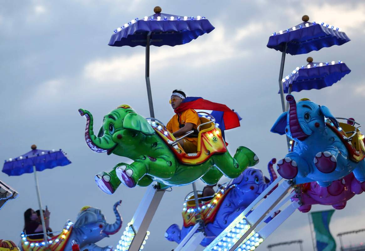 Phouvanh Sengchanh, of Anaheim, Calif., enjoys a carnival ride during the second day of the Ele ...