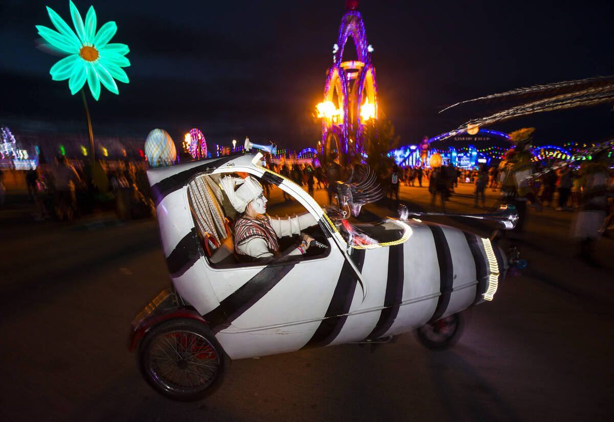 A costumed performer drives around the speedway during the second day of the Electric Daisy Car ...