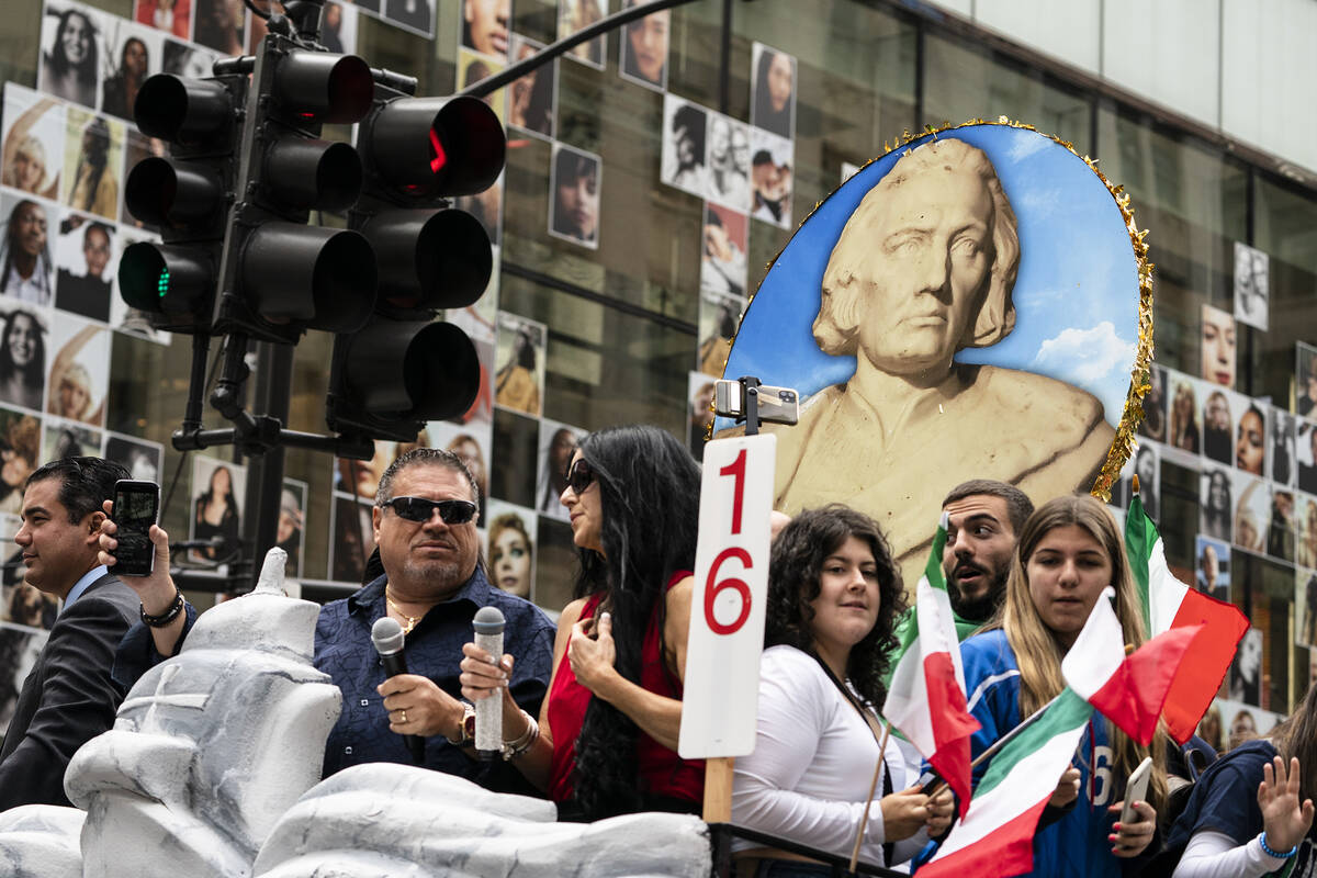 A likeness of Christopher Columbus is displayed atop a float as participants roll up Fifth Aven ...