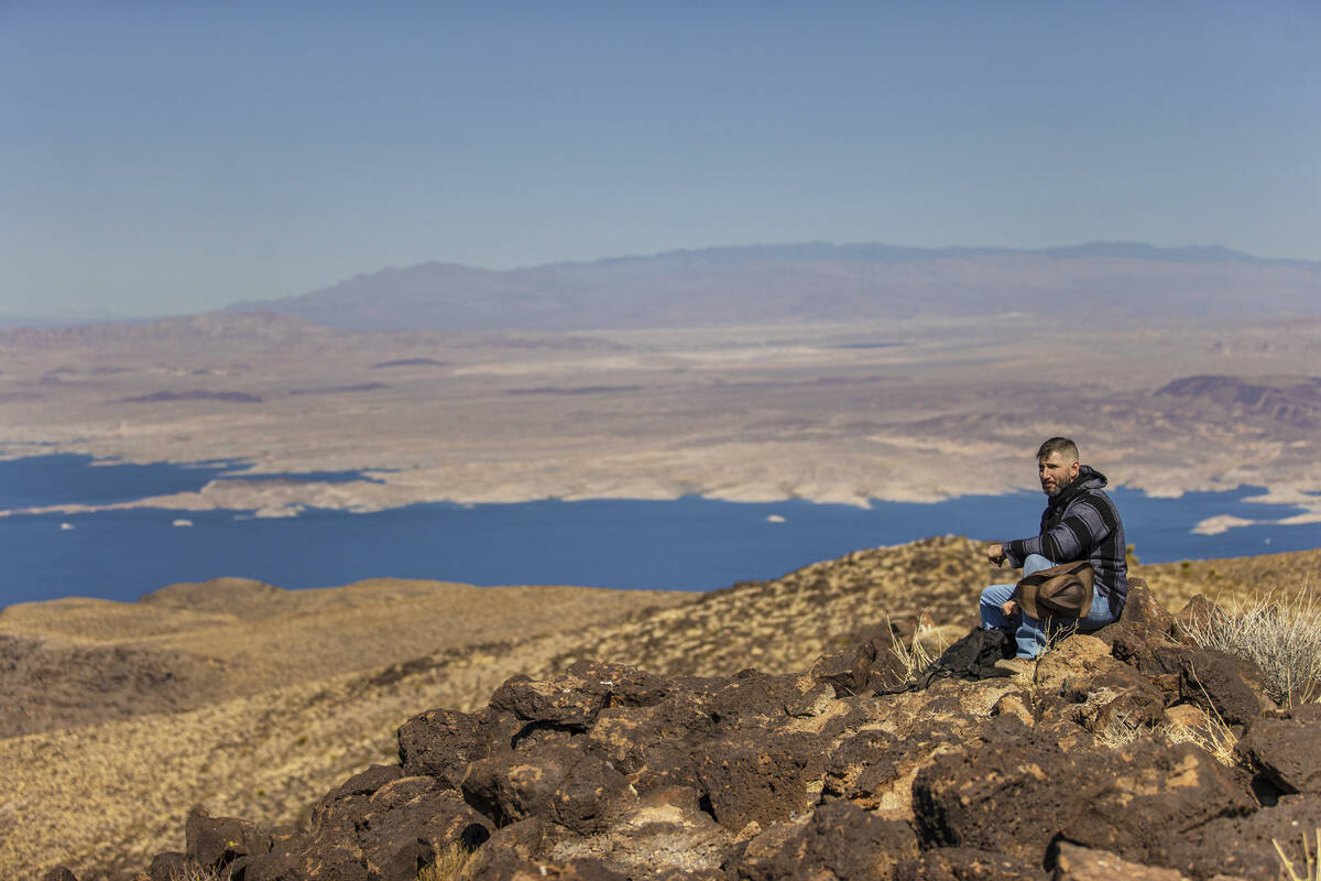 In this March 30, 2021, file photo, 52 Peaks hiker Christopher Wagemann looks out at Lake Mead ...