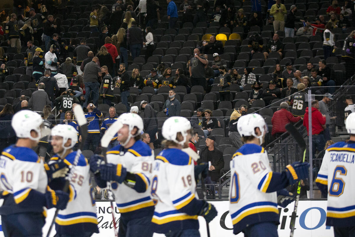 The Blues congratulate each other after beating the Golden Knights as fans vacate their seats a ...