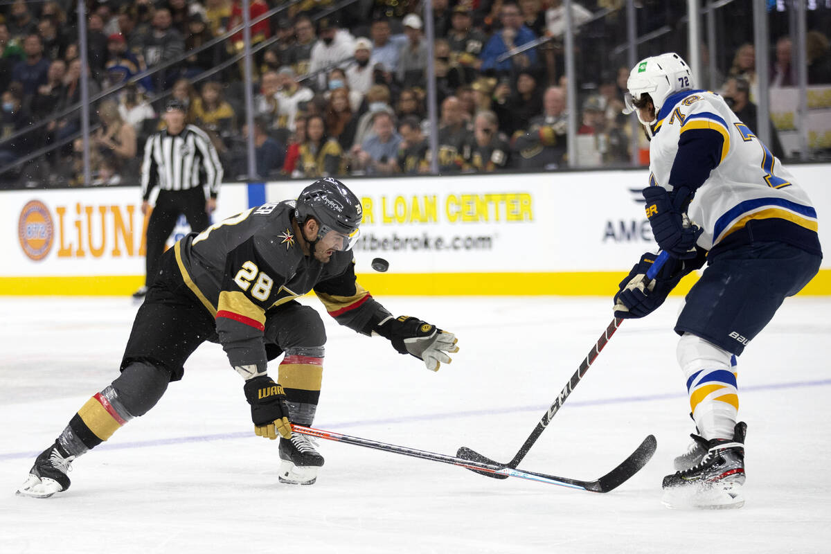Golden Knights left wing William Carrier (28) attempts to regain control of the puck while Blue ...