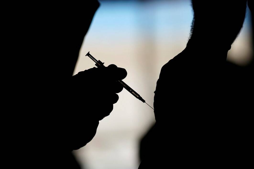 A man receives a COVID-19 vaccine at a vaccination site in Las Vegas in February 2021. (AP Phot ...
