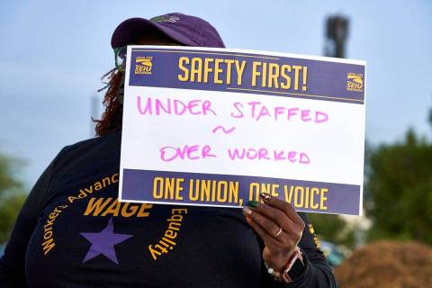 An employee with SEIU, Local 1107, protests unsafe working conditions in the Clark County Depar ...