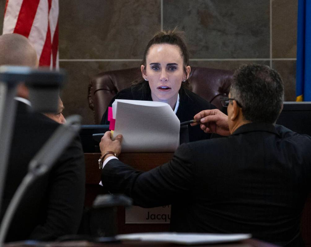 Prosecutors and defense attorneys confer with judge Jacqueline Bluth after they delivered their ...