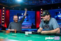 Adam Friedman, left, celebrates after showing his winning hand to defeat Phil Hellmuth in the $ ...