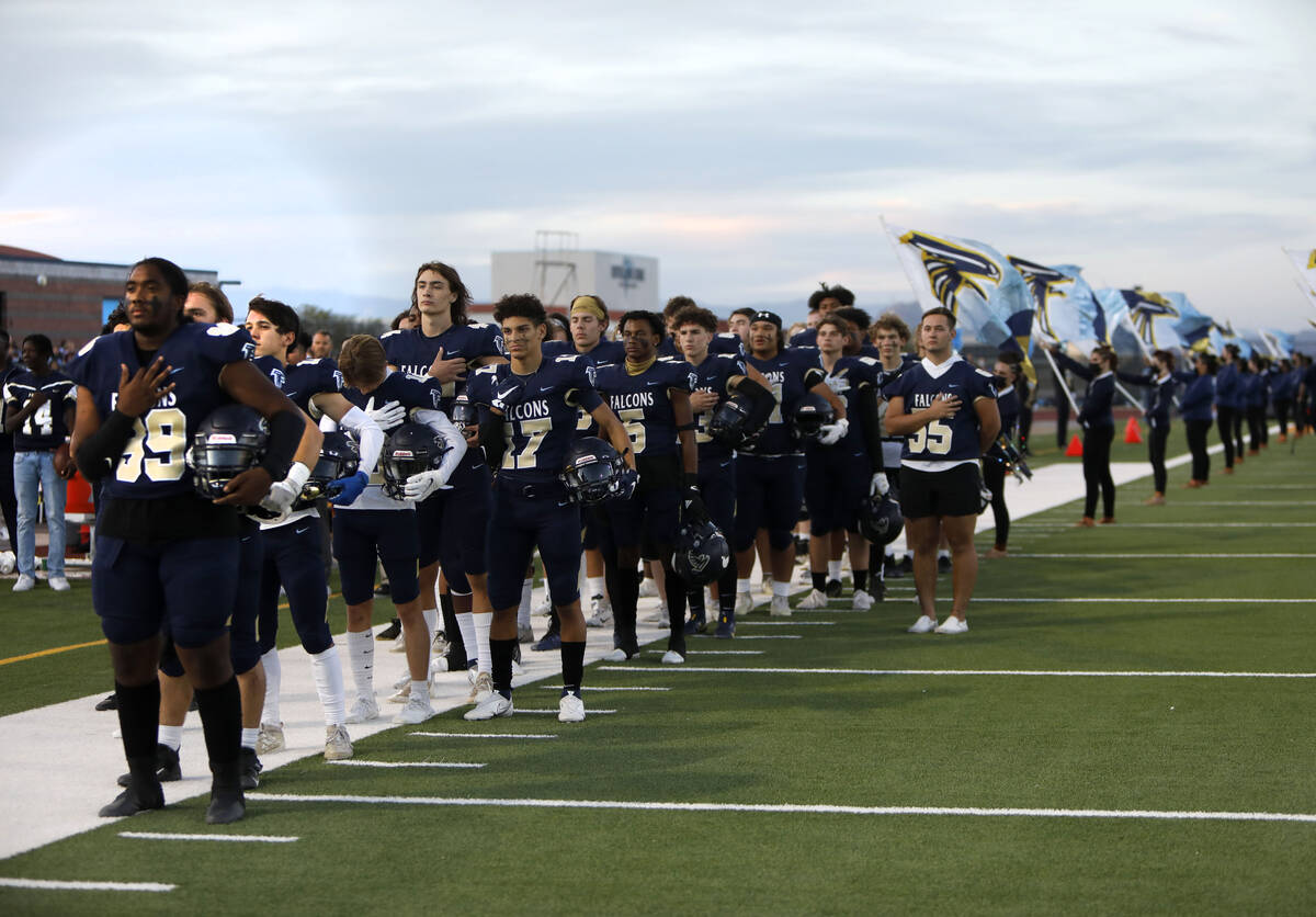 Foothill High School's players line up for the national anthem before a football game against B ...