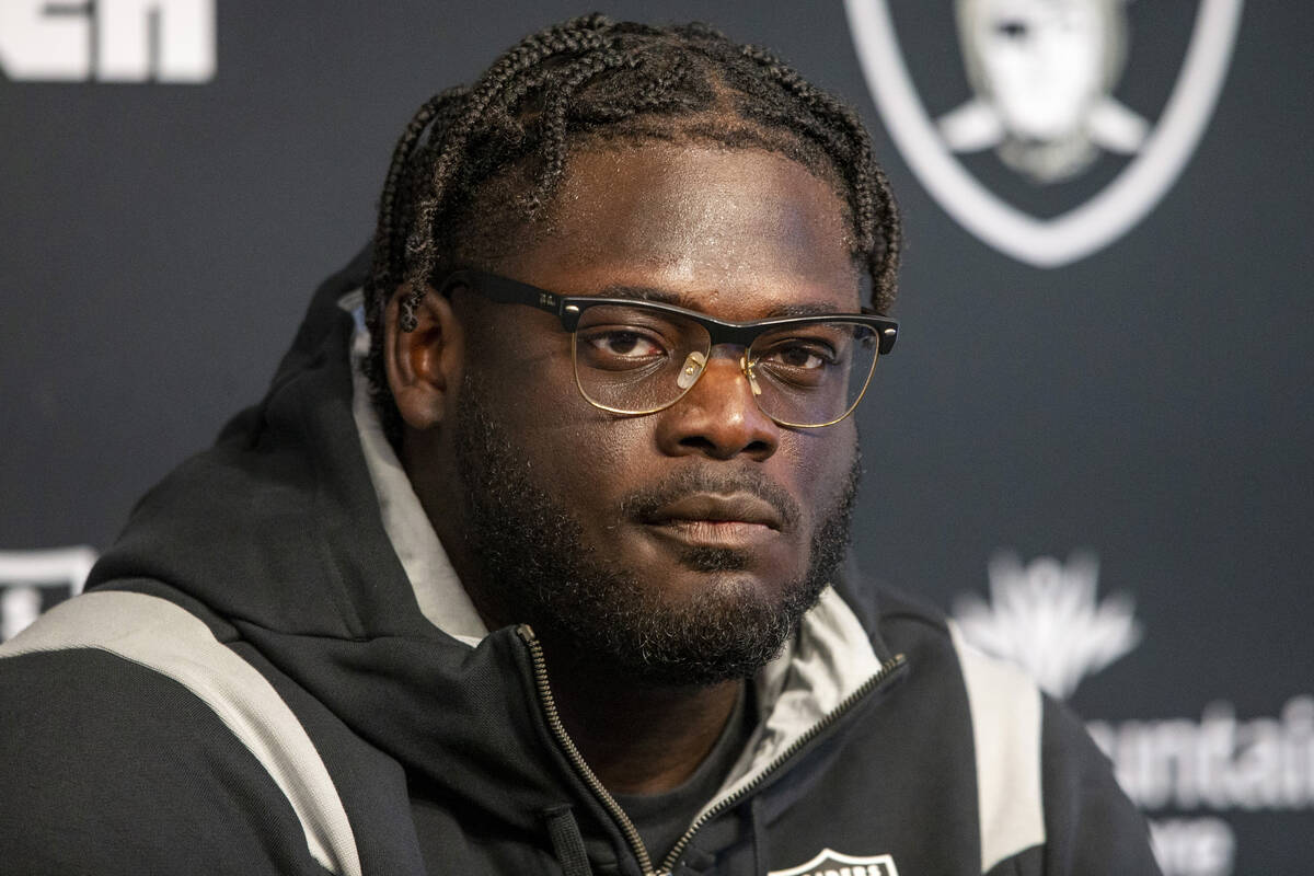 Raiders offensive tackle Alex Leatherwood listens to questions during a news conference at the ...