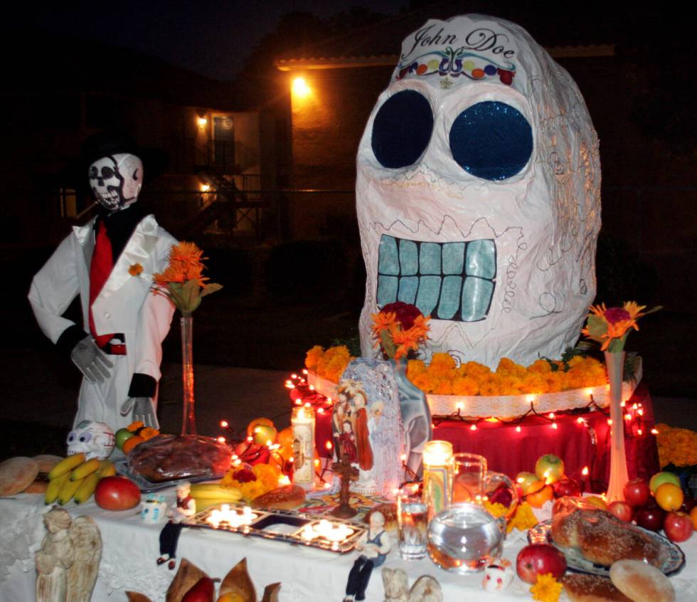 An "ofrenda," or offering alter, is shown during a Dia de los Muertos, or "Day of the Dead," fe ...