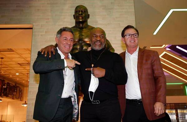 Former boxer Mike Tyson, center, poses for photos with Mulberry Street Pizzeria founder and own ...