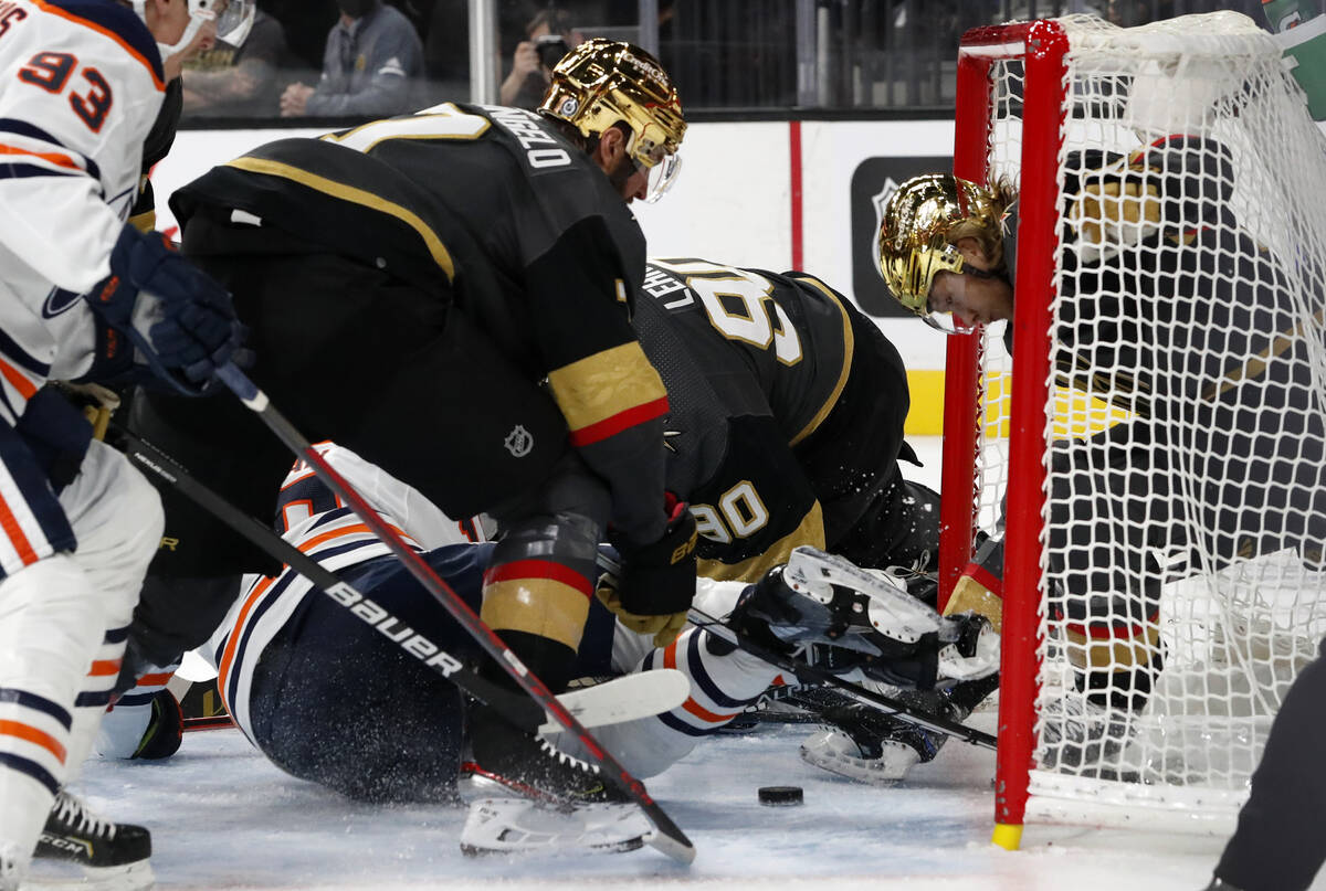 Edmonton Oilers left wing Zach Hyman, bottom, scores as Vegas Golden Knights center William Kar ...