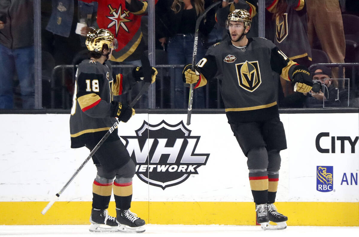 Vegas Golden Knights center Nicolas Roy (10) celebrates with left wing Peyton Krebs (18) after ...