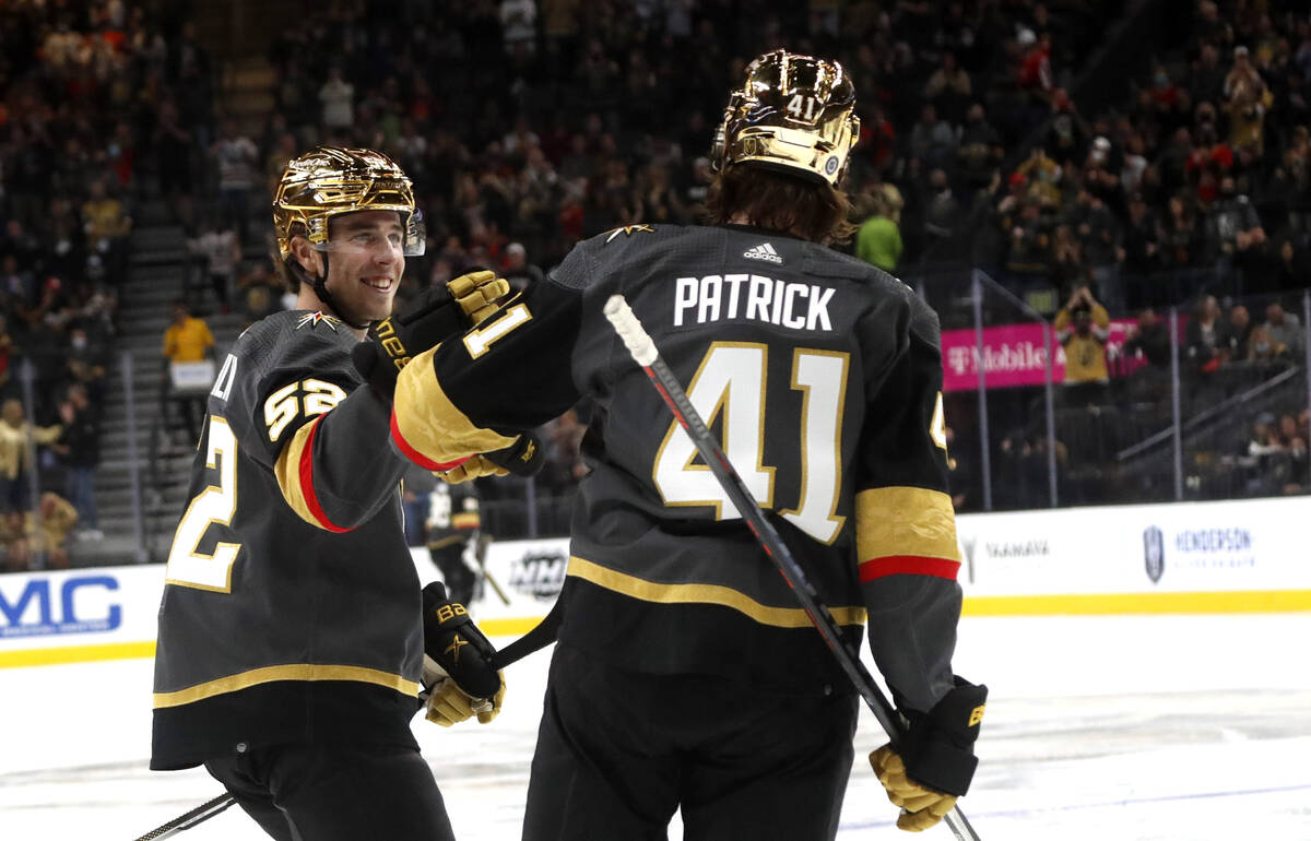 Vegas Golden Knights defenseman Dylan Coghlan (52) congratulates center Nolan Patrick (41) afte ...