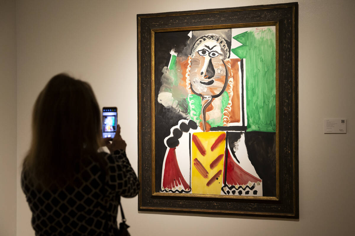 A visitor photographs Pablo Picasso's "Buste d'homme" at the Bellagio Gallery of Fine Art on Fr ...