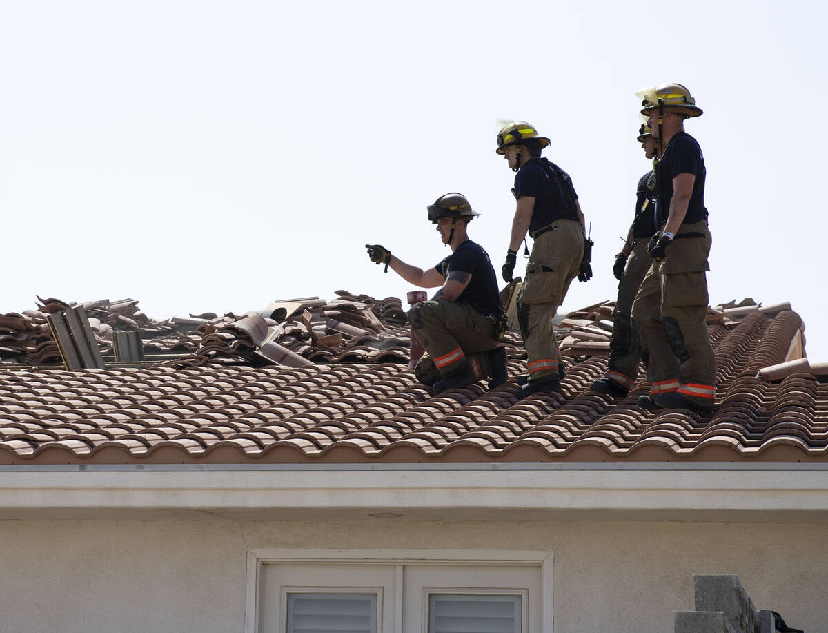 The Clark County firefighters prepare a house for a controlled burn at Schuster Street in Las V ...