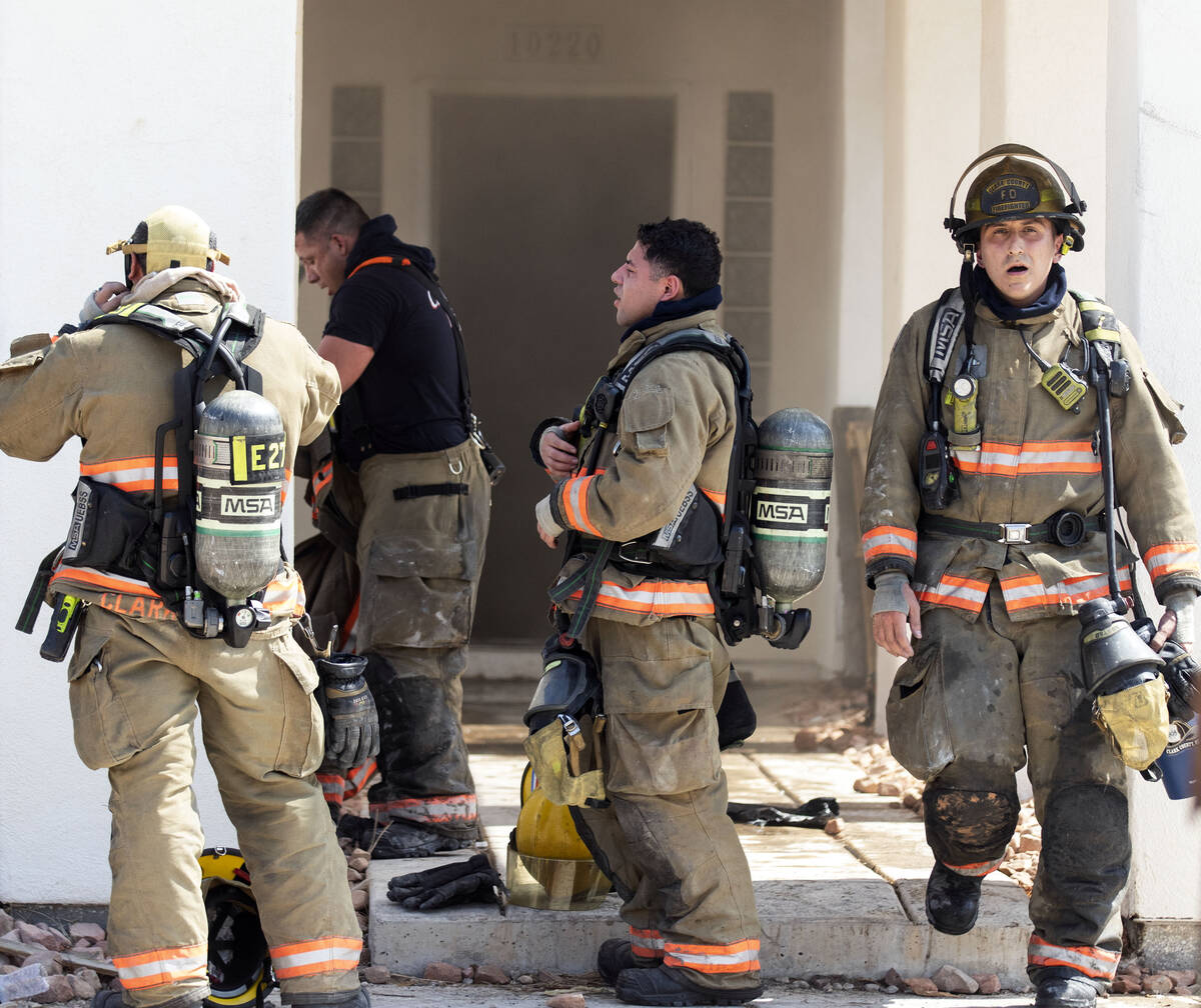 The Clark County firefighters take a break outside a house being used for fire training on Schu ...