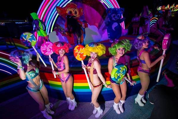 Costumed performers pose for pictures during the first day of the Electric Daisy Carnival at th ...