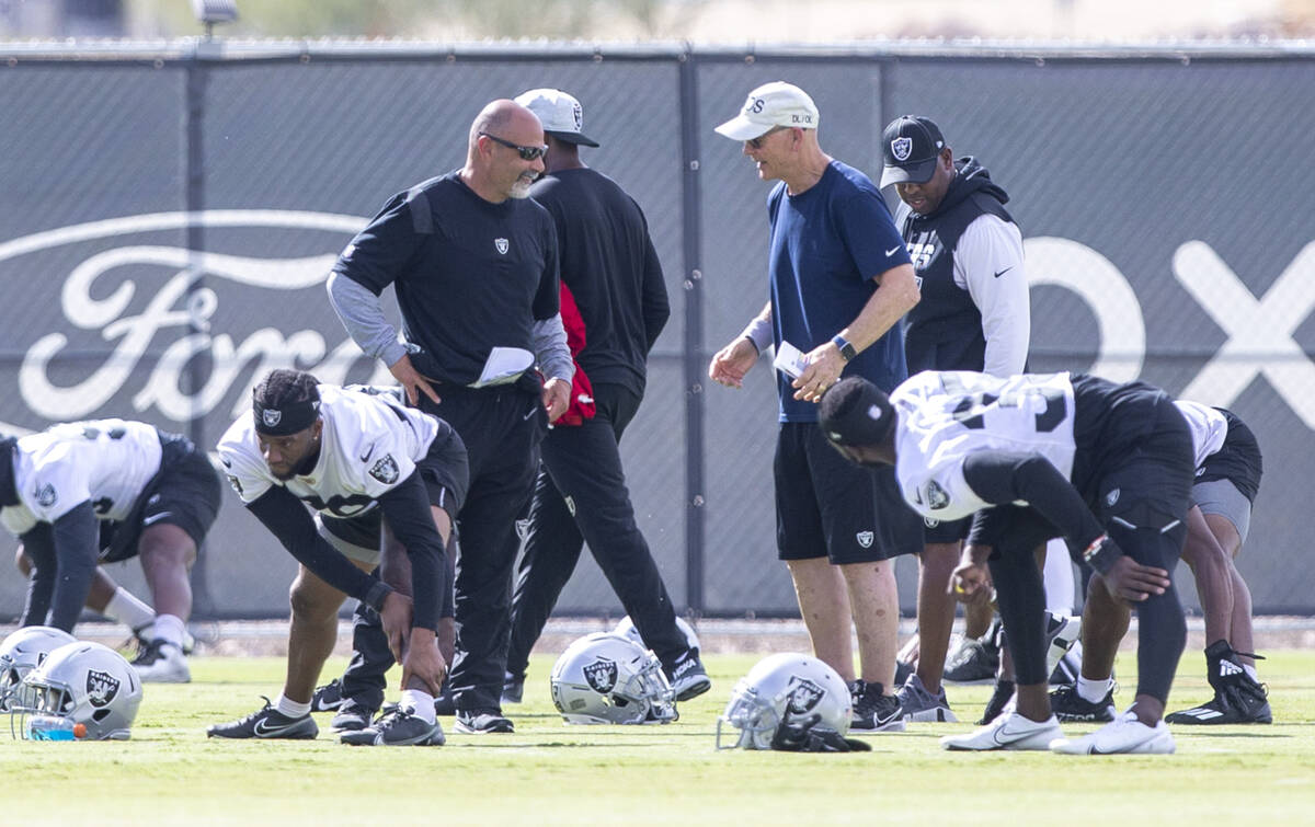 Raiders interim head coach Rich Bisaccia and defensive line coach Rod Marinelli interact during ...